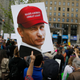 A demonstrator holds up a sign featuring an image of Vladimir Putin wearing a Donald Trump campaign cap during an anti-Trump rally on June 3, 2017, in New York City. (Eduardo Munoz Alvarez/Getty Images)